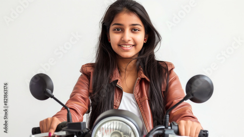 Beautiful Indian college girl on scooty on white background photo