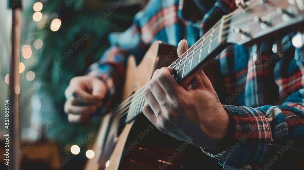 Naklejka premium A man plays a guitar in front of a microphone on a stage