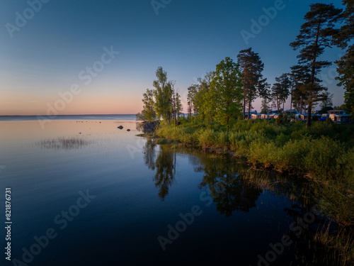 Scenic Aerial View of Reflecting Swedish Forest Lake During Sunset photo