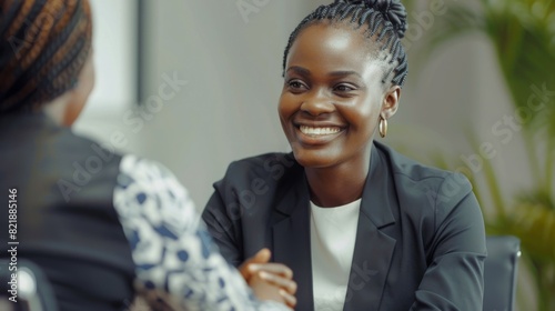 Fototapeta Naklejka Na Ścianę i Meble -  Happy african business woman handshaking at office meeting. Smiling female hr hiring recruit at job interview, bank or insurance agent, lawyer making deal with client at work