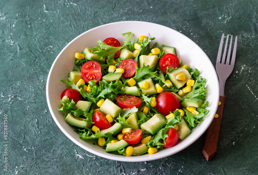 Salad with avocado, tomatoes and corn. Healthy eating. Vegetarian food.