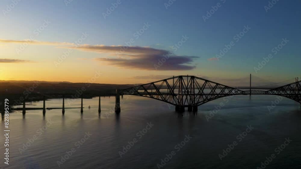 Aerial view of Forth Rail Bridge at sunset over water, Edinburgh, Scotland. Aerial view of Forth Rail Bridge at sunset over water, Edinburgh, Scotland.