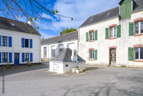Locmaria in Belle-Ile, Brittany, typical street in the village, a fountain in the center
