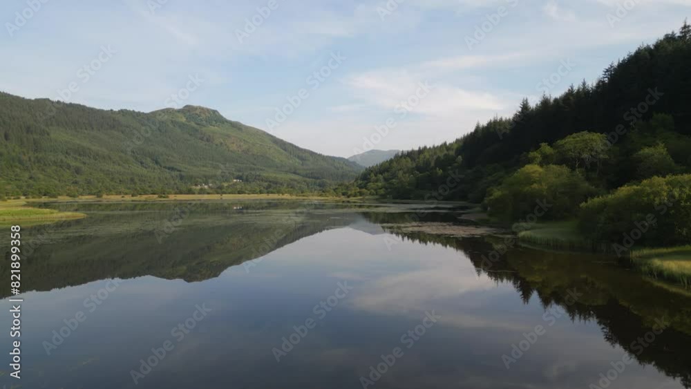 Aerial view of Loch Lubnaig surrounded by serene mountains and lush forest, Highlands, United Kingdom. Aerial view of Loch Lubnaig surrounded by serene mountains and lush forest, Highlands, United Kingdom.