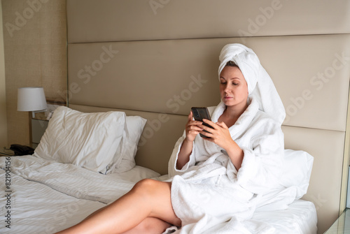 Woman in a bathrobe relaxes after a spa in a hotel.