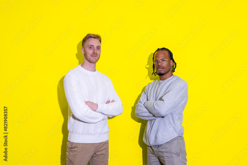 Fototapeta premium Two businessmen standing in front of a yellow wall