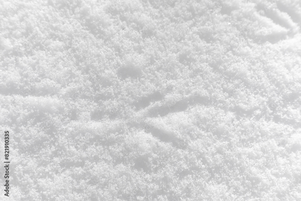 Fototapeta premium Footprints of birds on the snow close-up, background, texture