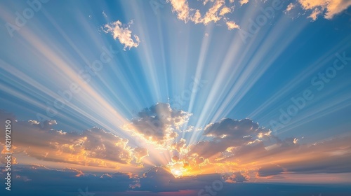 Sun rays breaking through clouds in a radiant morning sky photo