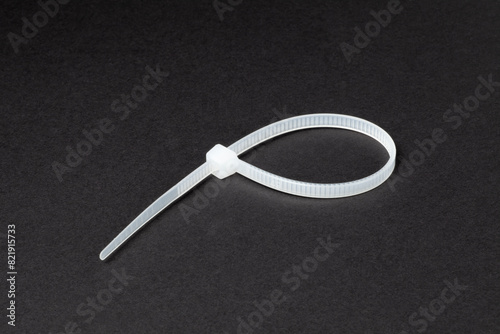 Plastic self-locking nylon cable ties on black background