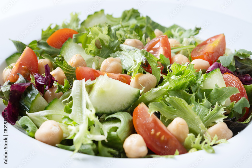 Healthy chickpea salad with tomato,lettuce and cucumber isolated on white background. Close up Healthy chickpea salad with tomato,lettuce and cucumber isolated on white background. Close up