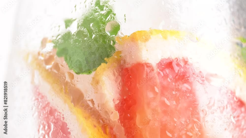 Drops of water flowing from a glass with lemonade. A refreshing summer drink