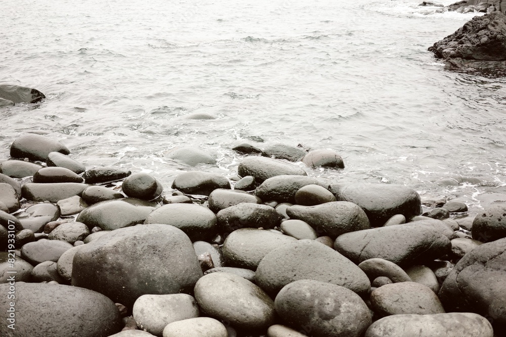 Expansive stretch of rocky beach washed by the lapping waves of the sea Expansive stretch of rocky beach washed by the lapping waves of the sea