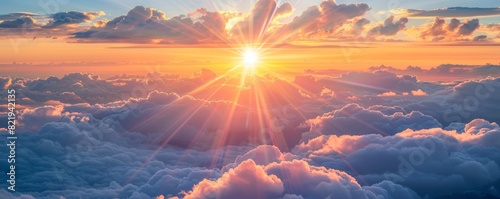 Bright sunrise above the clouds with dramatic beams
