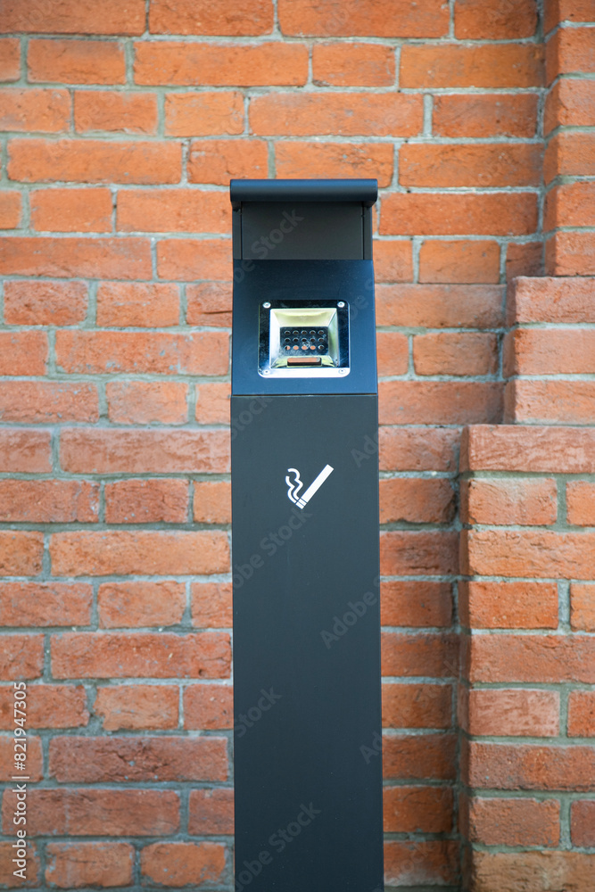 An outdoor receptacle for cigarette butts.