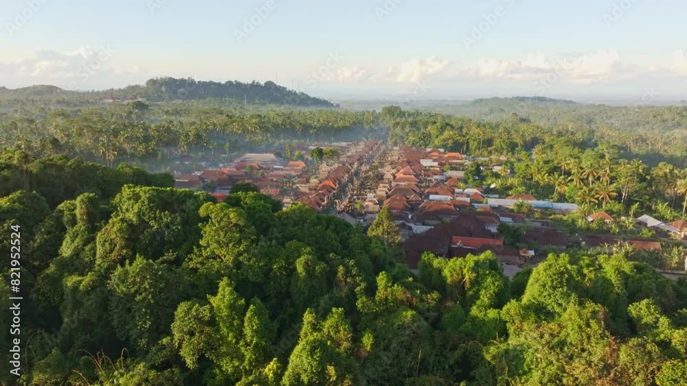 Aerial view of traditional village surrounded by lush forest and hills, Penglipuran, Bali, Indonesia. Aerial view of traditional village surrounded by lush forest and hills, Penglipuran, Bali, Indonesia.