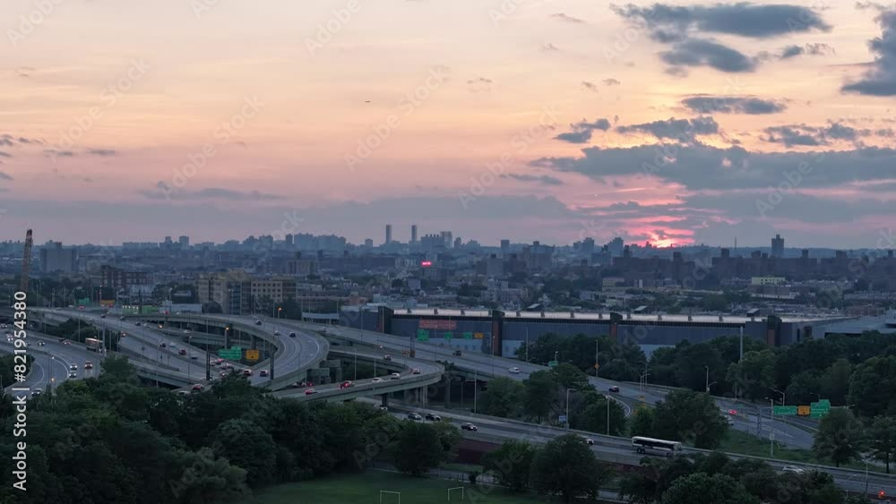 Time-lapse of a bridge with traffic and city in the background with cloudy sky at sunset Time-lapse of a bridge with traffic and city in the background with cloudy sky at sunset