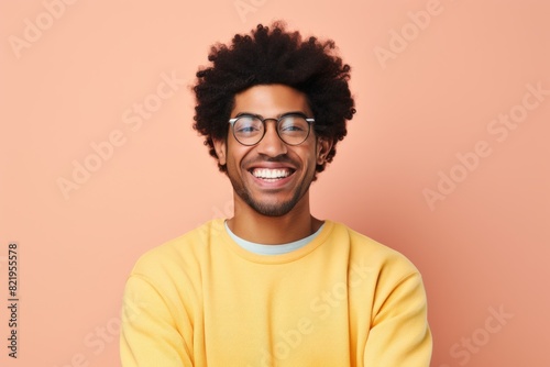 Portrait of a smiling afro-american man in his 20s smiling at the camera isolated in solid pastel color wall