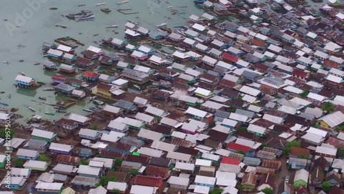 Aerial view of fishing village at sunrise with dense population by the sea, Bungin Island, Indonesia. photo