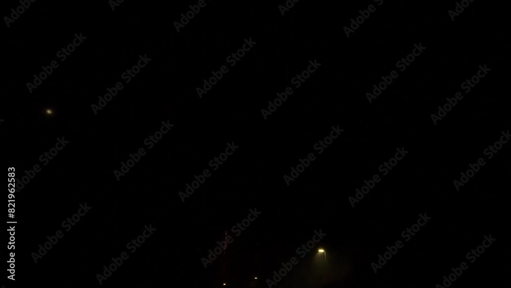 Glowing firework in dark sky at night in the city Glowing firework in dark sky at night in the city