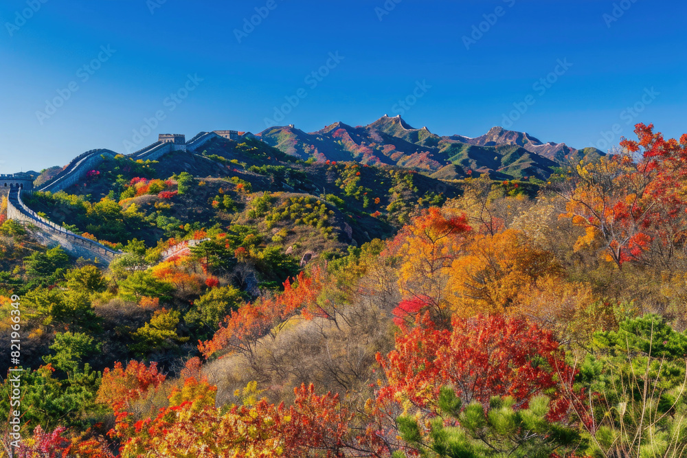 The Great Wall winding through vibrant autumn foliage under a clear blue sky