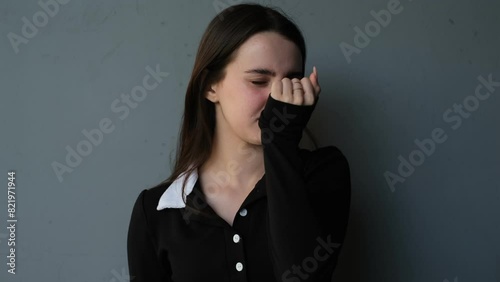 portrait of a young woman smelling a bad smell