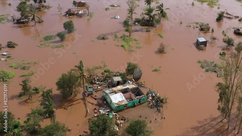 Drone footage over poor African people with damaged houses and trees in the flood in Mozambique