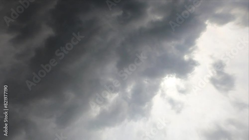 View of dense cloudscape moving fast in gray sky photo