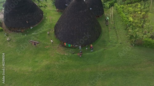 Aerial view of traditional village with thatched roofs and lush green surroundings, Wae Rebo, Flores, Indonesia. photo