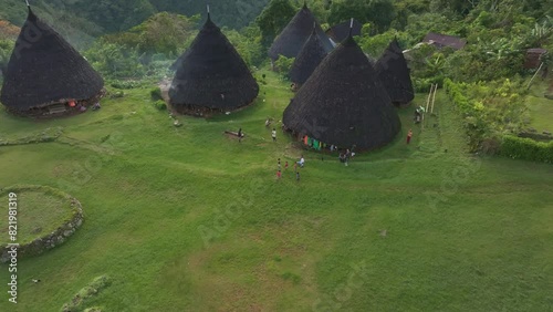 Aerial view of remote village with thatched roofs and lush greenery, Wae Rebo, Flores, Indonesia. photo