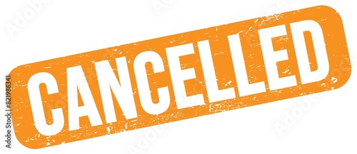 Фотография CANCELLED text on orange grungy stamp sign.