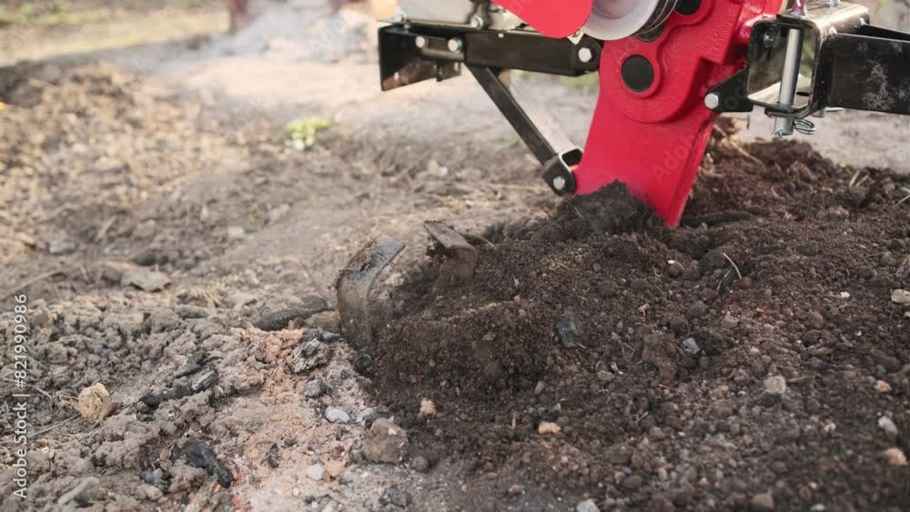 a tillerblock plows the land in the garden. A tillerblock for plowing the land, cultivating the soil in the garden and in the garden. a tillerblock plows the land in the garden. A tillerblock for plowing the land, cultivating the soil in the garden and in the garden.