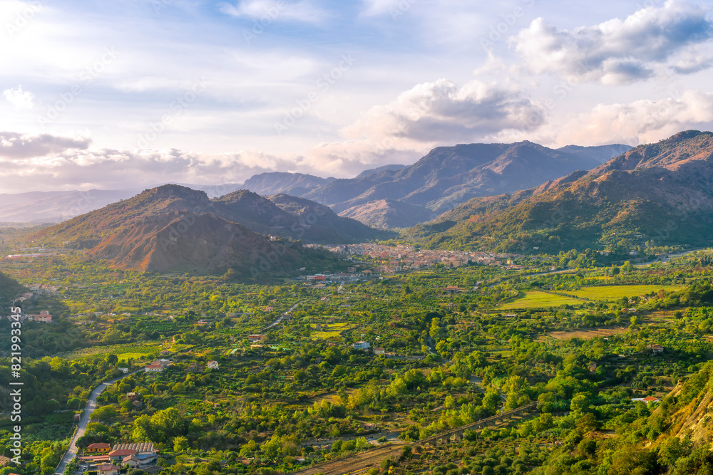 Obraz premium amazing highland view from above to a canyon and valley between mountains and green hills, cloudy sunset landscape of beautiful highland