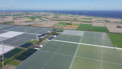 Aerial view of countryside with Greenhouses, solar panel, windturbine, Middenmeer, North Holland, Netherlands. photo