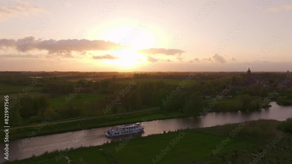 Aerial view of serene river Linge at sunset with charming village, Asperen, Netherlands.