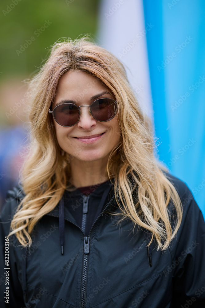 portrait of a woman with sunglasses smiling on blurred background. portrait of a woman with sunglasses smiling on blurred background.
