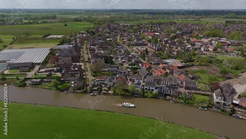 Aerial view of picturesque village along River Linge with charming boats and homes, Beesd, Gelderland, Netherlands. photo