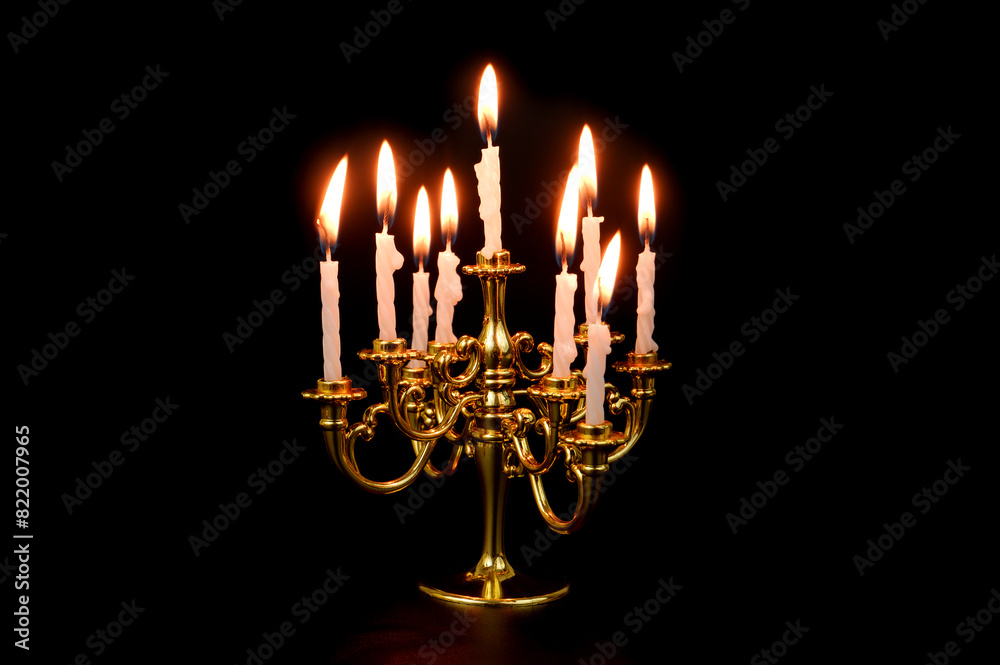 Candelabra with white burning candles isolated on black Candelabra with white burning candles isolated on black