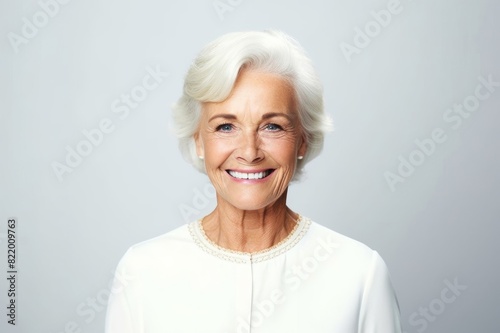 senior businesswoman smiling on white background