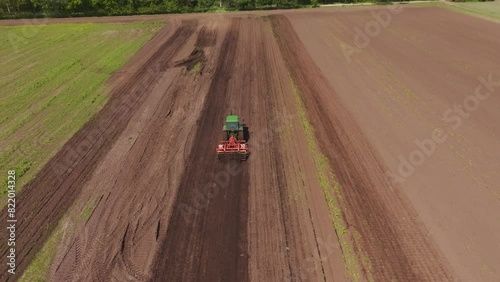 Aerial view of cultivated field with tractor and soil, Bourtange, Netherlands. photo