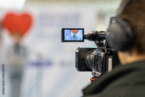 Digital camera in action, recording insightful moments at a media conference © Microgen