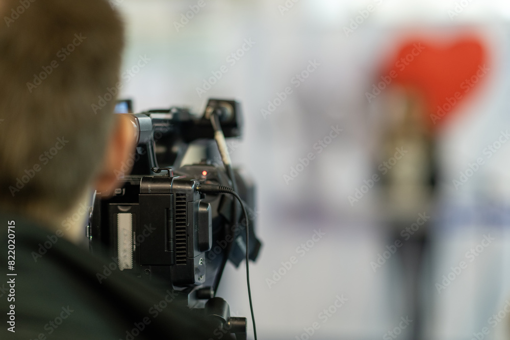 Digital camera in action, recording insightful moments at a media conference Digital camera in action, recording insightful moments at a media conference