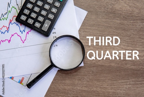 Top view image of text THIRD QUARTER on office desk. Third quarter concept.