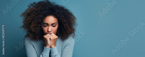 Blue background sad black independant powerful Woman realistic person portrait of young beautiful bad mood expression girl Isolated on Background racism skin color  photo