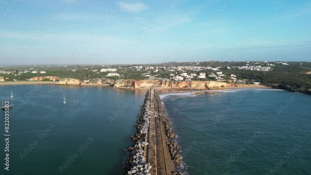 Aerial view of rocky cliff and sailboats at Portimao Port, Algarve, Portugal. Aerial view of rocky cliff and sailboats at Portimao Port, Algarve, Portugal.