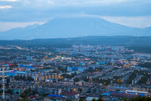 Morning cityscape. Top view of the buildings and streets of the city. Residential urban areas at twilight at dawn. A volcano in the distance. Petropavlovsk-Kamchatsky, Kamchatka, Far East of Russia. photo