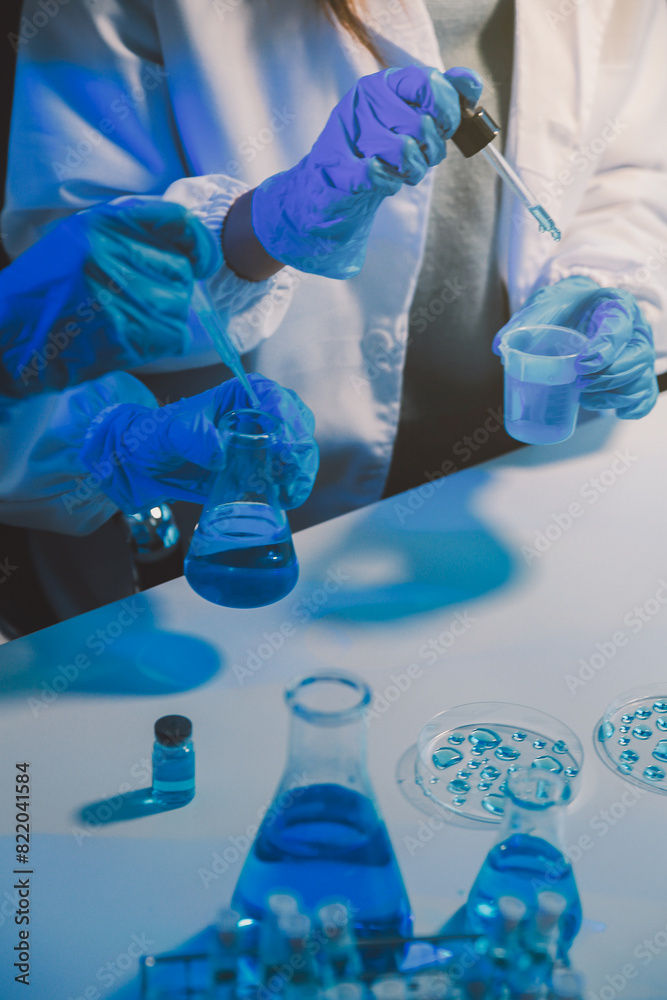 chemist,scientist hand dropping chemical liquid into test tube, science research and development concept chemist,scientist hand dropping chemical liquid into test tube, science research and development concept