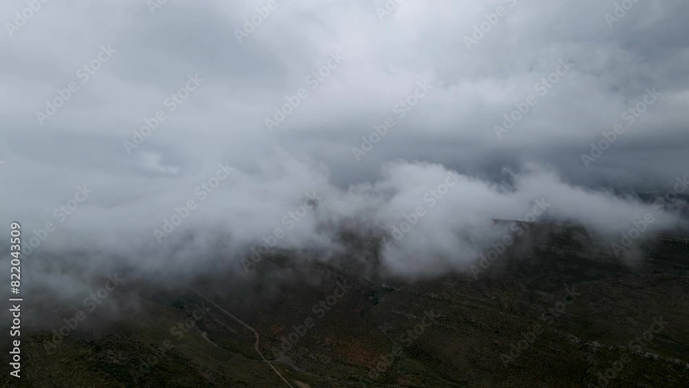 Aerial view of misty mountain range in Drie Kuilen Nature Reserve, Western Cape, South Africa. Aerial view of misty mountain range in Drie Kuilen Nature Reserve, Western Cape, South Africa.