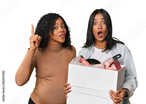 Latin women couple moving, one pregnant  having an idea, inspiration concept. photo