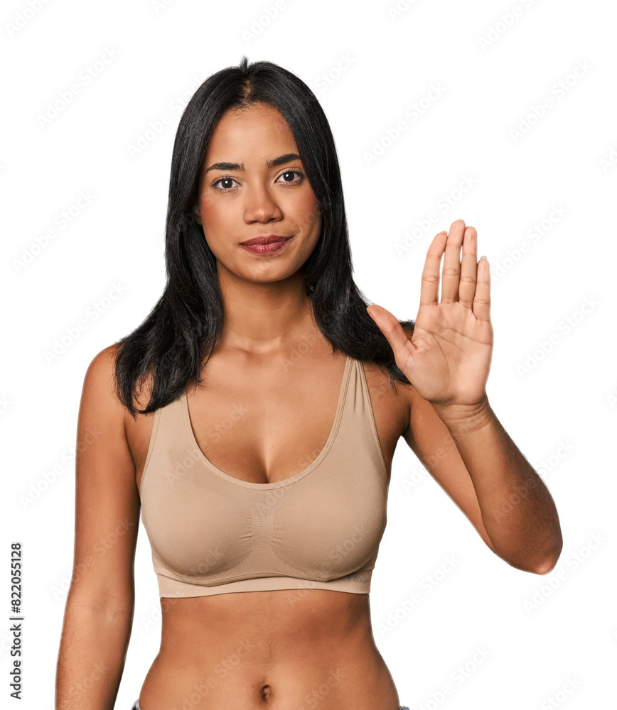 Young Filipino woman in light wear smiling cheerful showing number five with fingers. Young Filipino woman in light wear smiling cheerful showing number five with fingers.
