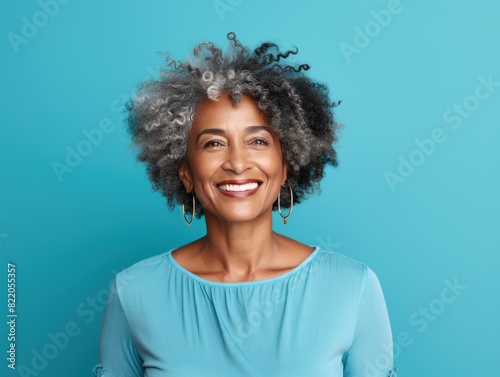 Cyan Background Happy black american independant powerful Woman. Portrait of older mid aged person beautiful Smiling girl Isolated on Background 